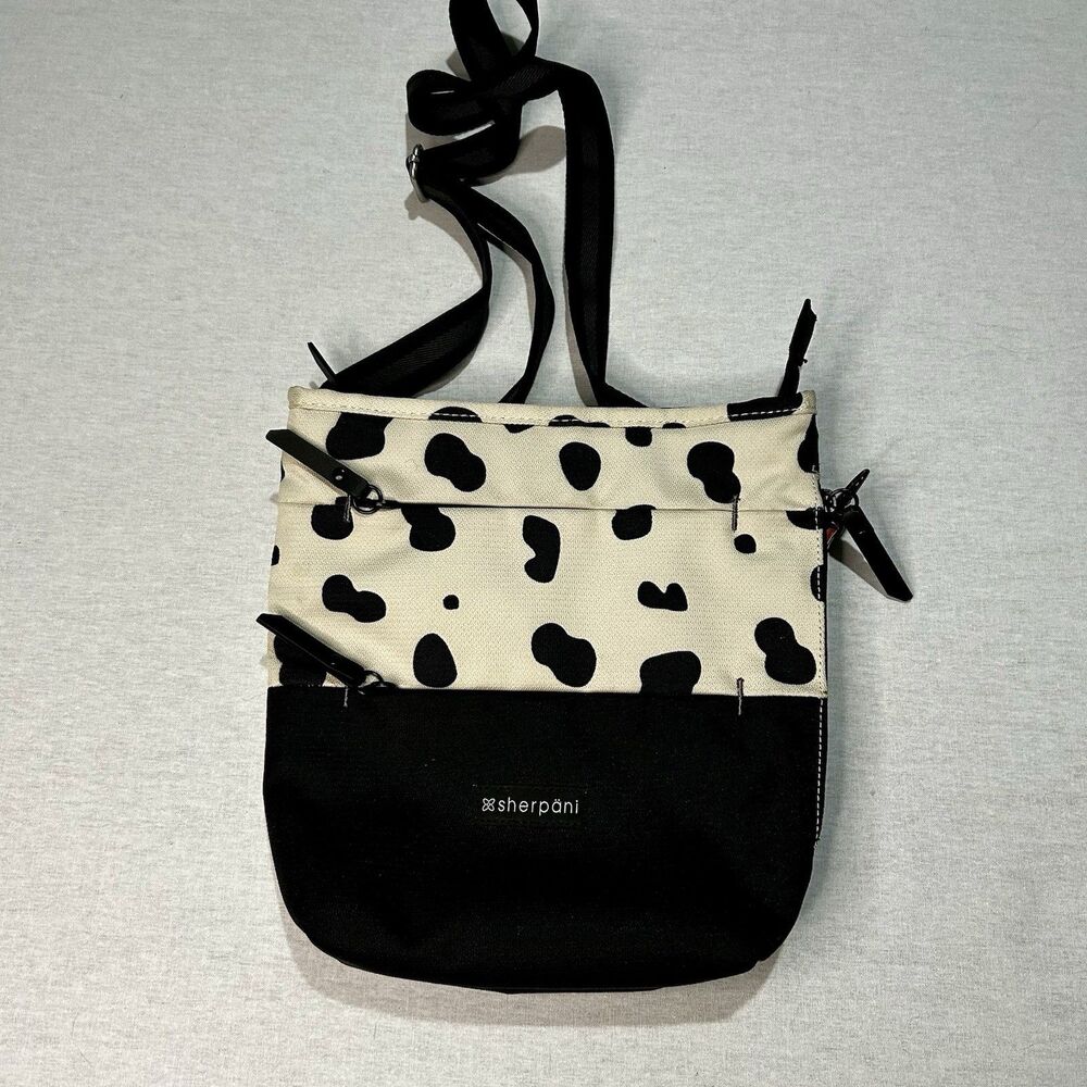 Sherpani crossbody bag in cow print, pockets galore, adjustable strap